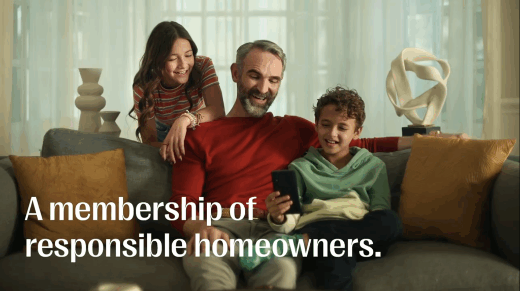 A man sits on a sofa with a young boy and girl, all smiling and looking at a smartphone—perhaps enjoying a viral campaign. Text reads, "A membership of responsible homeowners.